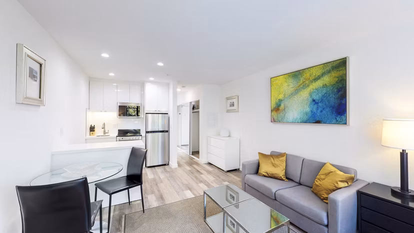 Living room featuring cozy furnishings and large windows at Telegraph Hill Apartments in a Greystar luxury community