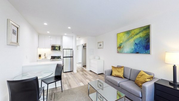 Living room featuring cozy furnishings and large windows at Telegraph Hill Apartments in a Greystar luxury community