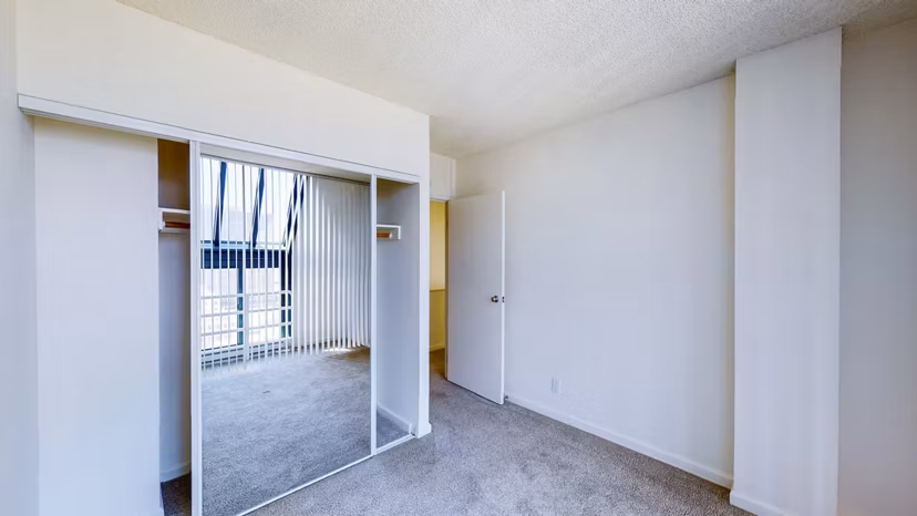 Bedroom with modern decor and ample natural light at Trinity Towers Apartments