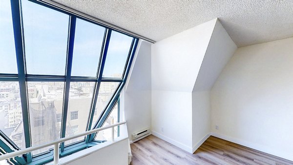 Luxurious bedroom with modern decor at Trinity Towers Apartments in San Francisco, featuring elegant design and ample natural light