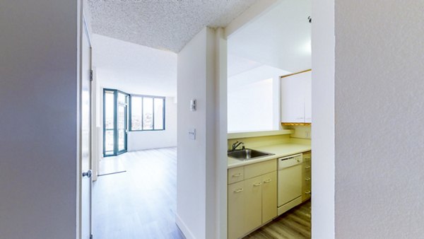 Sleek kitchen featuring stainless steel appliances in Trinity Towers Apartments