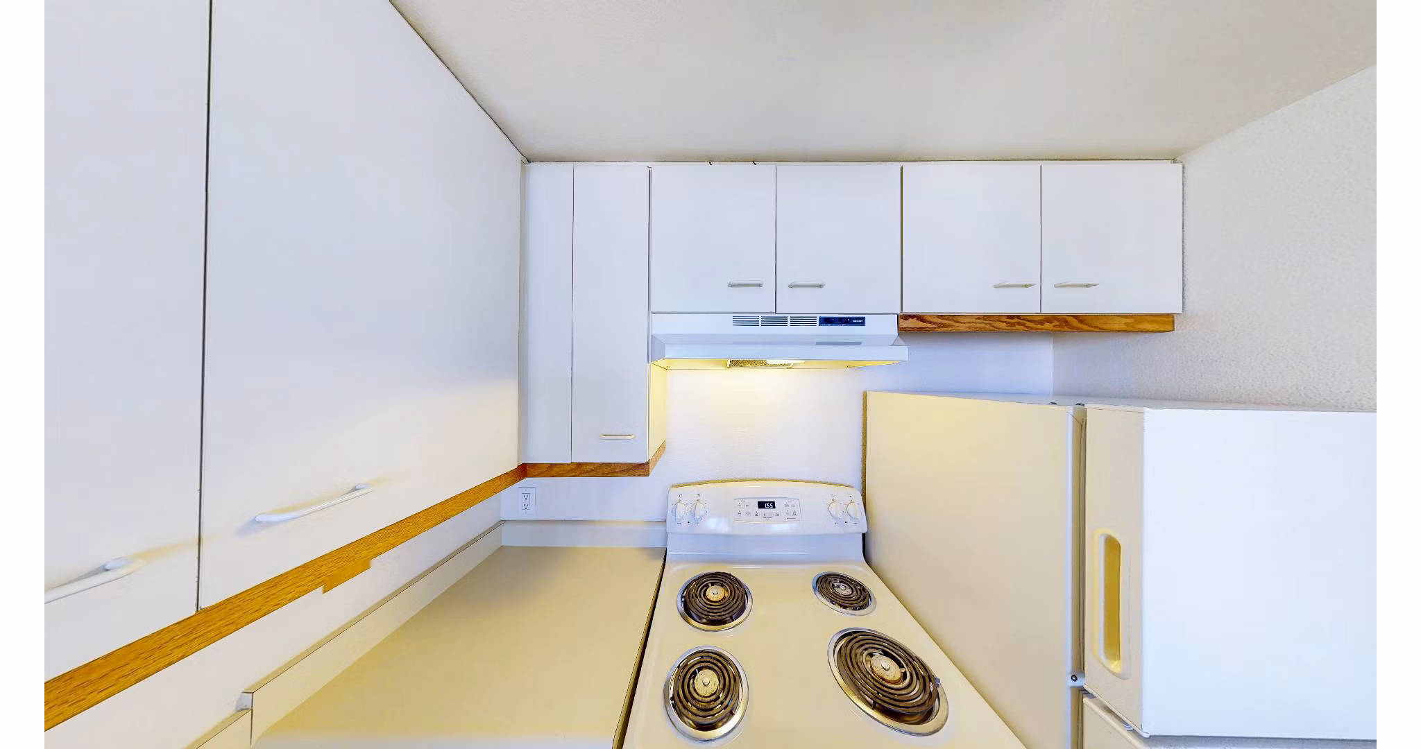 Modern kitchen with sleek countertops and stainless steel appliances at Trinity Towers Apartments