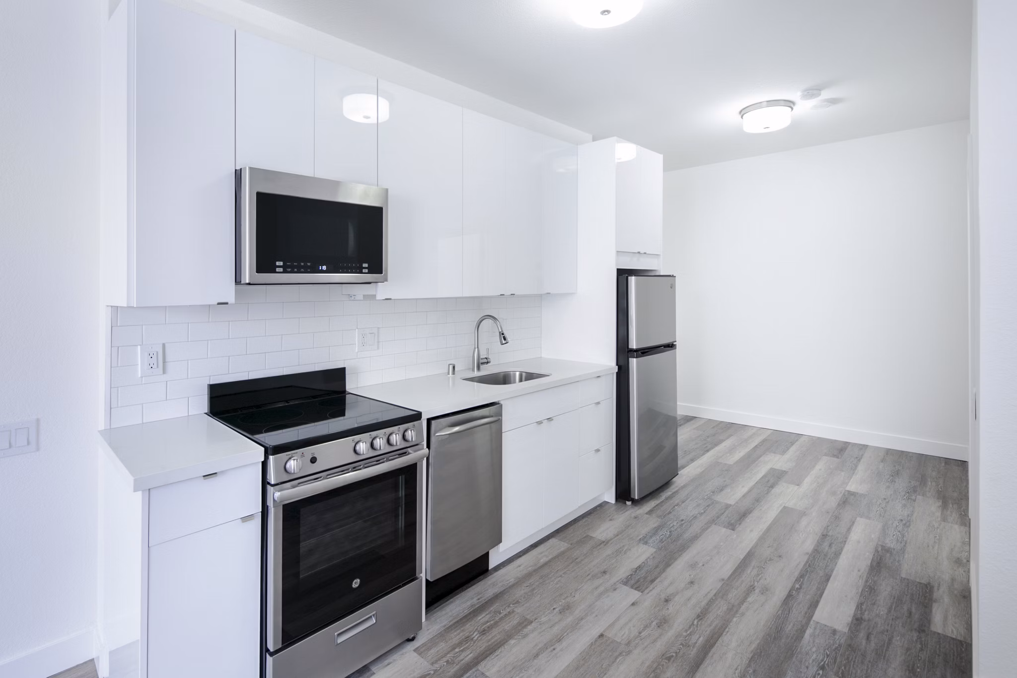 Modern kitchen with stainless steel appliances at Trinity Towers Apartments