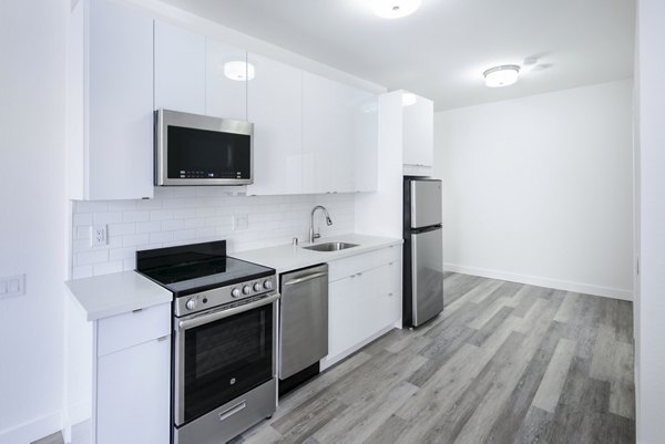 Modern kitchen with stainless steel appliances at Trinity Towers Apartments