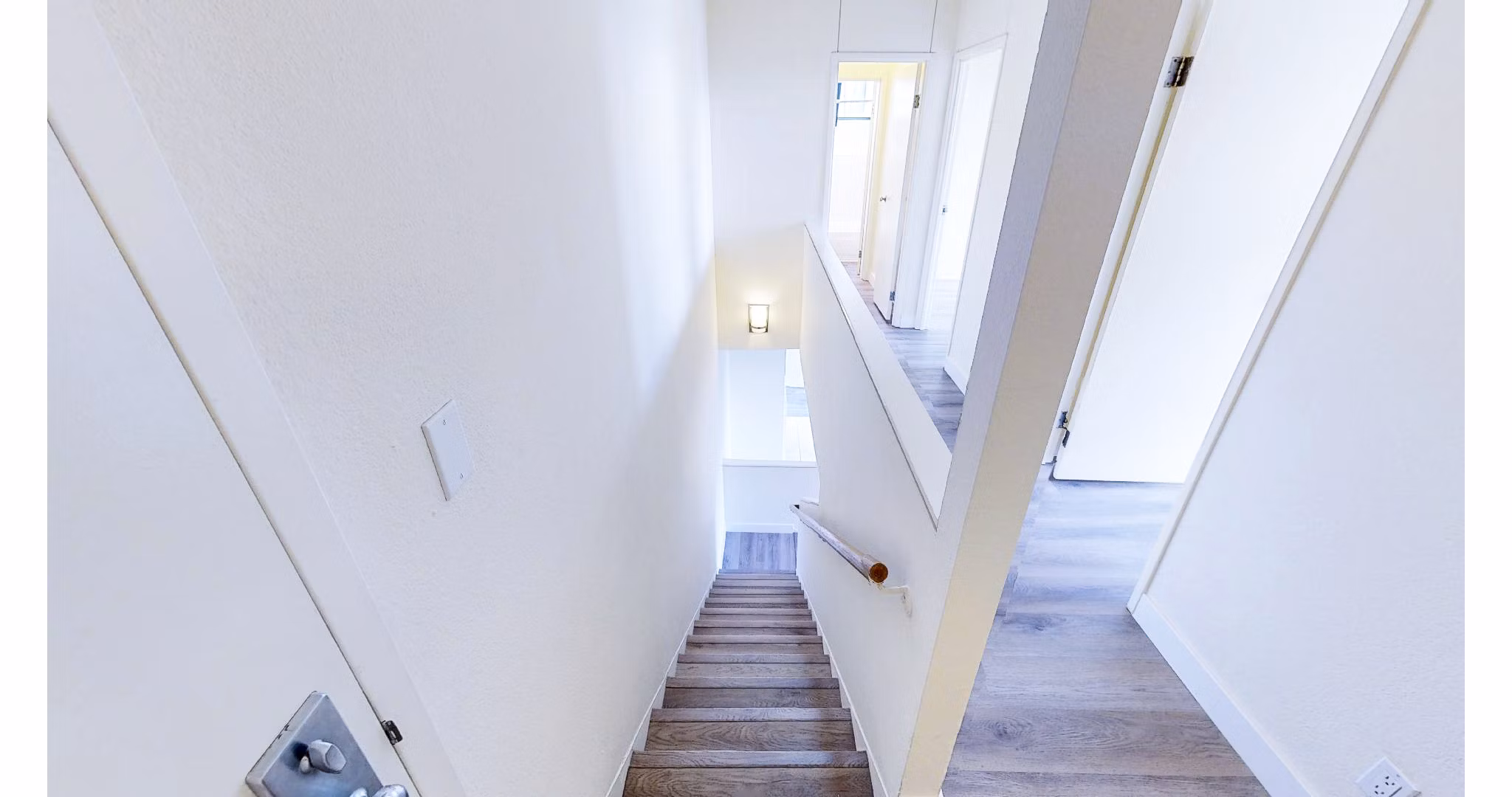 Elegant hallway with modern lighting and art at Trinity Towers Apartments