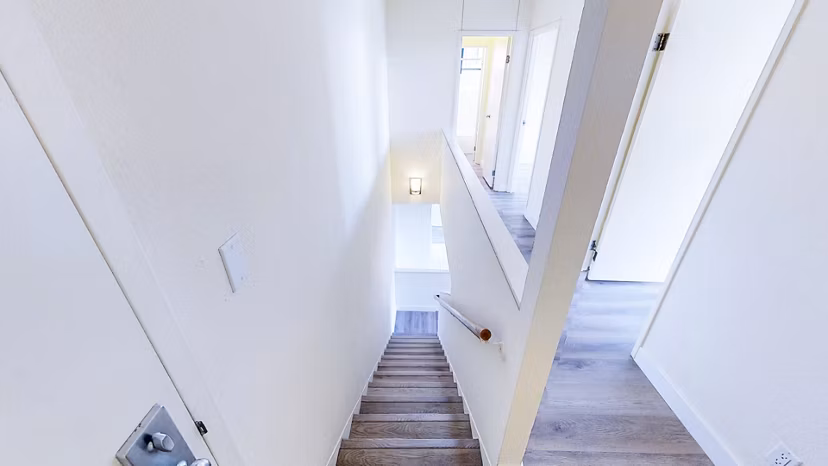 Elegant hallway with modern lighting and art at Trinity Towers Apartments