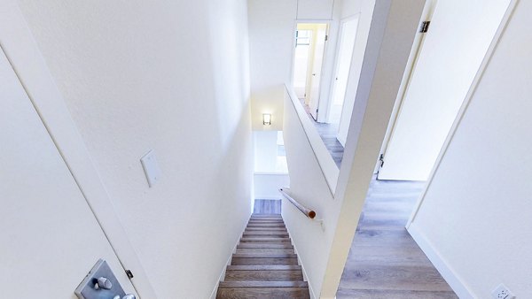 Elegant hallway with modern lighting and art at Trinity Towers Apartments