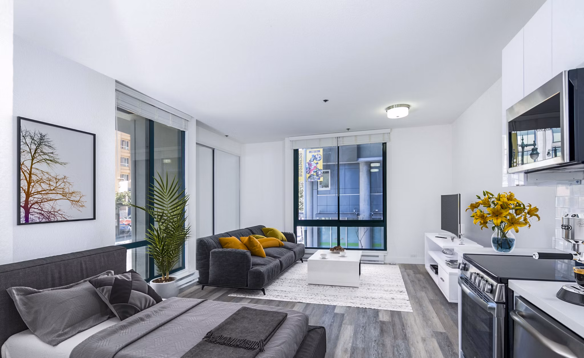 Studio apartment with modern furnishings and a cozy bedroom at Trinity Towers Apartments, a luxury Greystar property in an urban setting