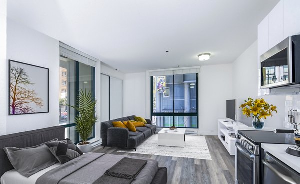 Studio apartment with modern furnishings and a cozy bedroom at Trinity Towers Apartments, a luxury Greystar property in an urban setting