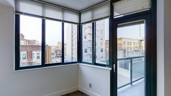 Spacious balcony at Trinity Towers Apartments featuring city skyline views