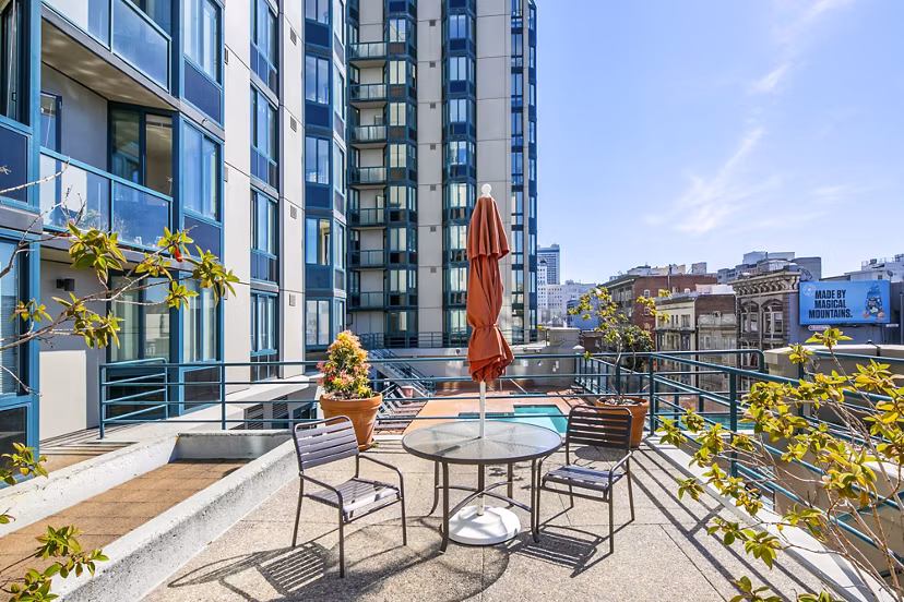 Patio with comfortable seating and city views at Trinity Towers Apartments, perfect for outdoor relaxation and entertainment