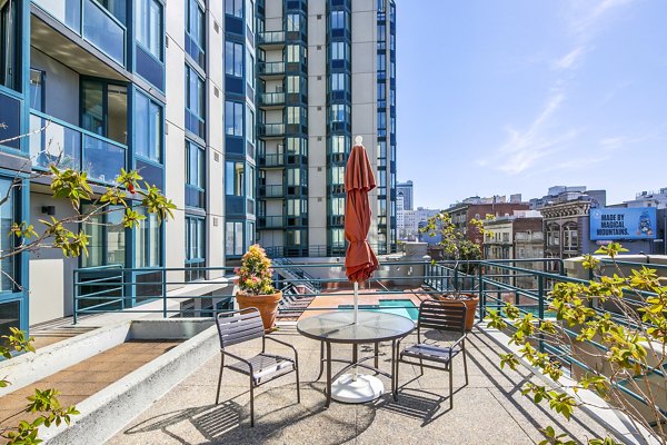 Patio with comfortable seating and city views at Trinity Towers Apartments, perfect for outdoor relaxation and entertainment