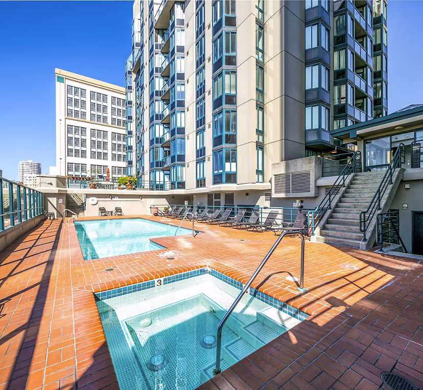 Outdoor pool with lush landscaping at Trinity Towers Apartments in luxury setting