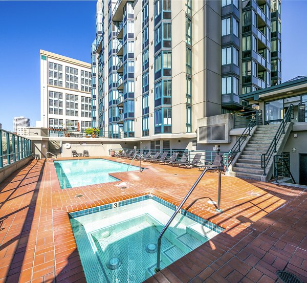 Outdoor pool with lush landscaping at Trinity Towers Apartments in luxury setting