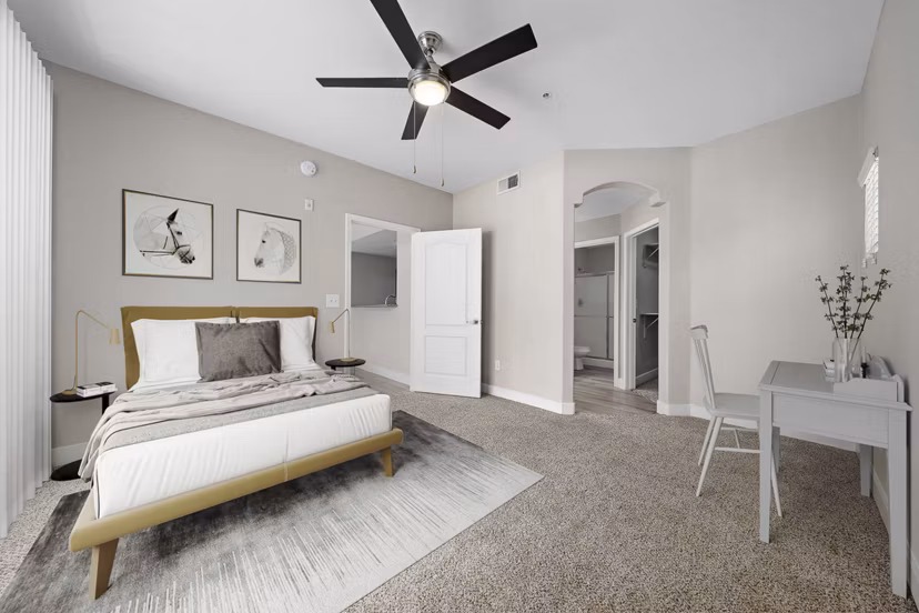 Bedroom featuring modern furnishings and city views at The Met at 3rd and Fillmore Apartments