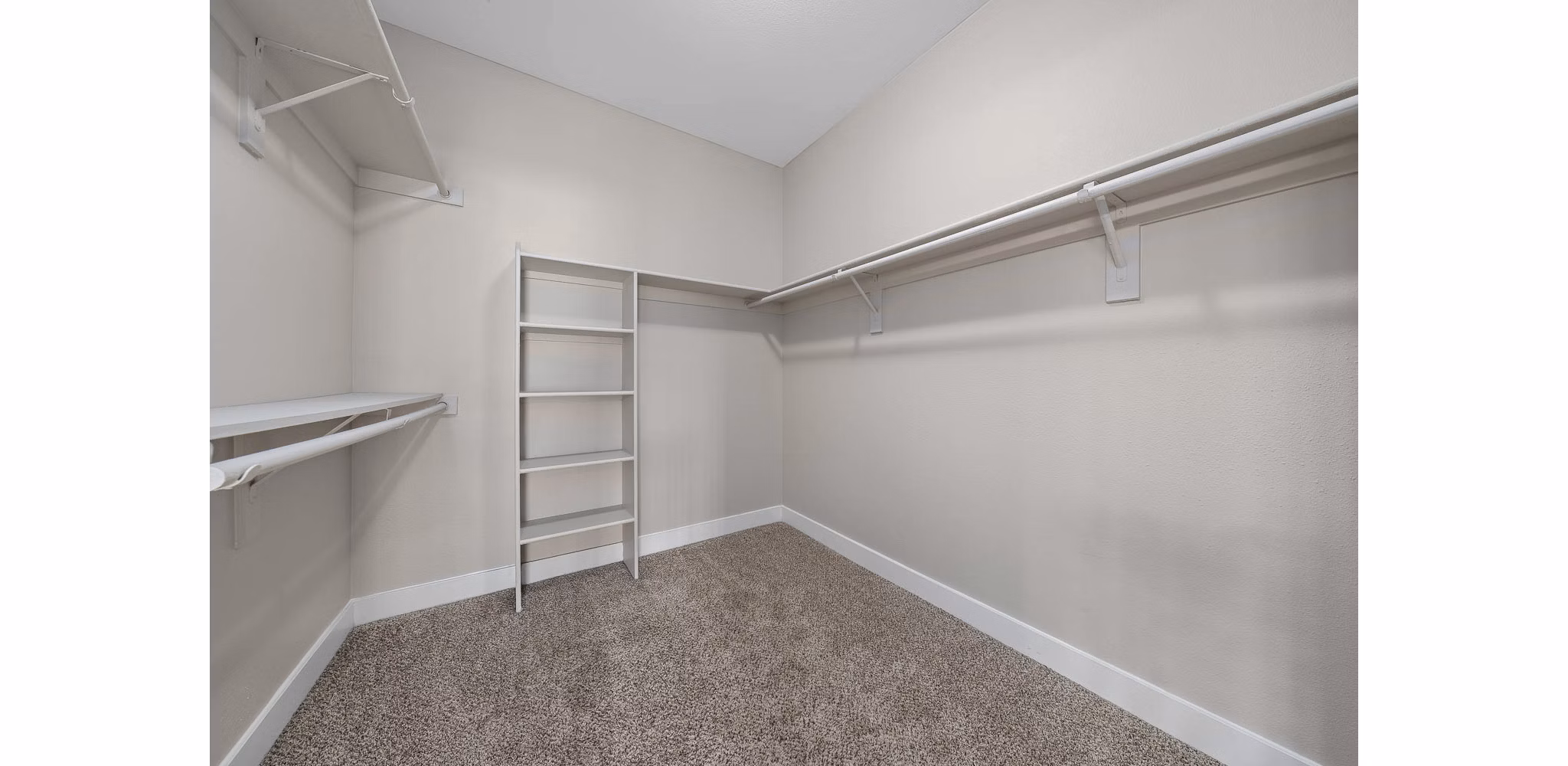 Walk-in closet with custom shelving in The Met at 3rd and Fillmore Apartments
