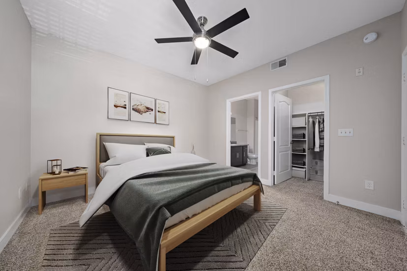 Elegant bedroom with modern decor and city views at The Met at 3rd and Fillmore Apartments