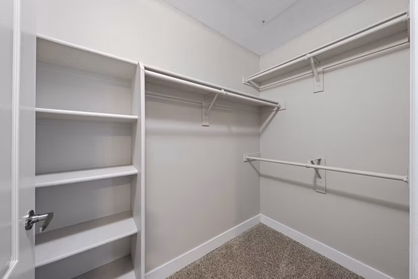 Cozy bedroom with elegant design at The Met at 3rd and Fillmore Apartments