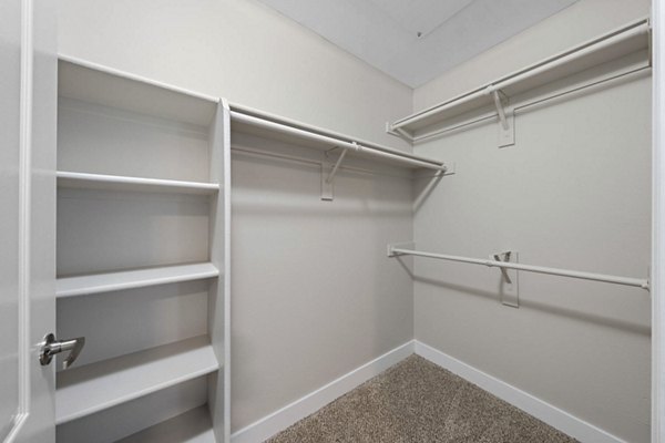Cozy bedroom with elegant design at The Met at 3rd and Fillmore Apartments