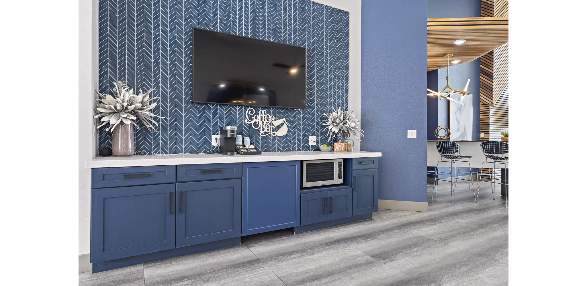 Clubhouse with modern seating and open floor plan at The Met at 3rd and Fillmore Apartments, ideal for social gatherings or relaxation