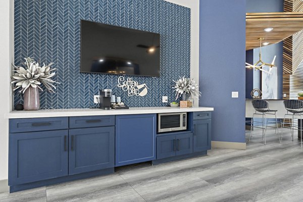 Clubhouse with modern seating and open floor plan at The Met at 3rd and Fillmore Apartments, ideal for social gatherings or relaxation