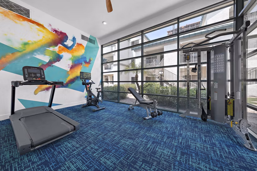 State-of-the-art fitness center with cardio machines at The Met at 3rd and Fillmore Apartments