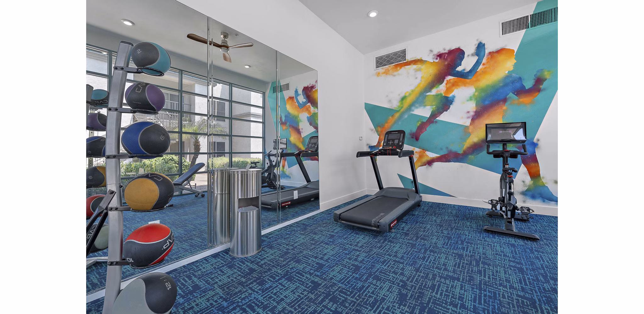 Modern fitness center with state-of-the-art equipment at The Met at 3rd and Fillmore Apartments for luxurious living experiences