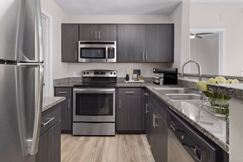 Sleek kitchen with stainless steel appliances at The Met at 3rd and Fillmore Apartments