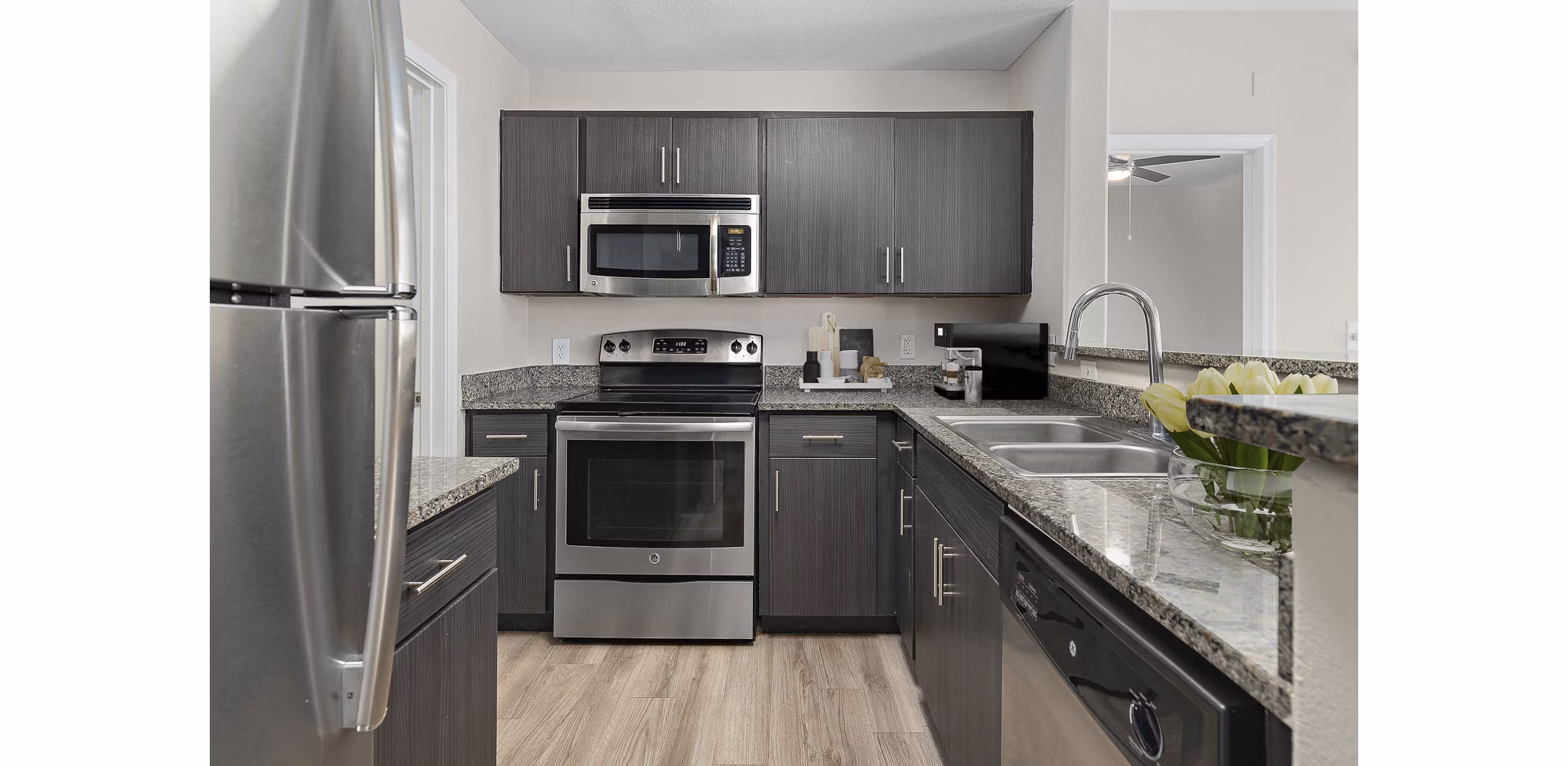 Sleek kitchen with stainless steel appliances at The Met at 3rd and Fillmore Apartments