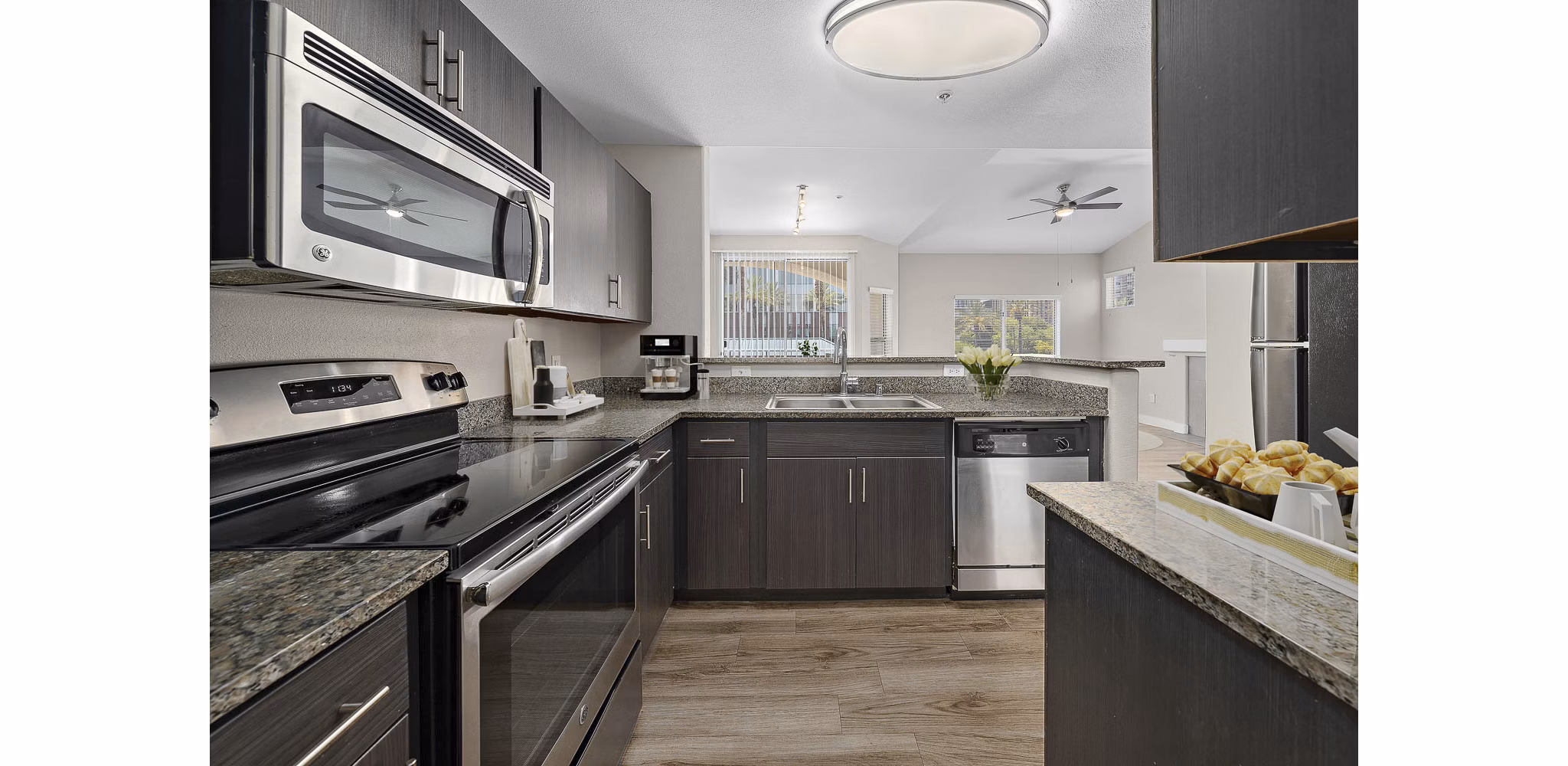 Kitchen with sleek cabinetry and modern appliances at The Met at 3rd and Fillmore Apartments