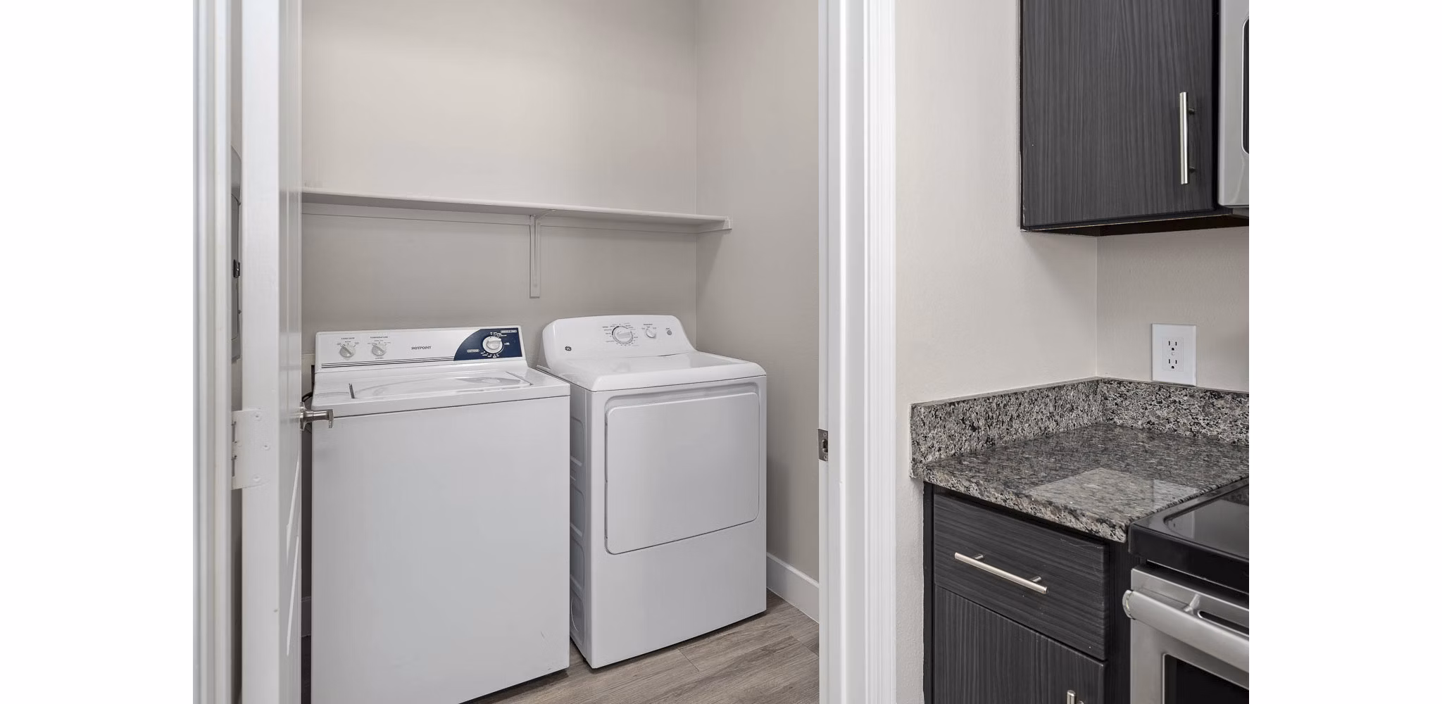 Laundry room with high-efficiency washers and dryers at The Met at 3rd and Fillmore Apartments