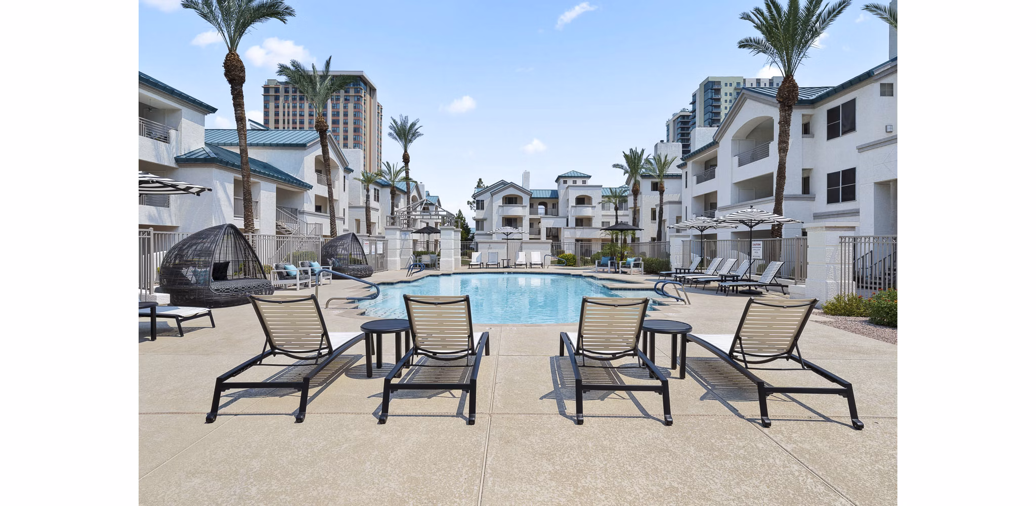 Resort-style pool with sun loungers at The Met at 3rd and Fillmore Apartments