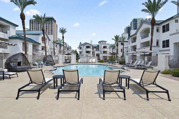 Resort-style pool with sun loungers at The Met at 3rd and Fillmore Apartments