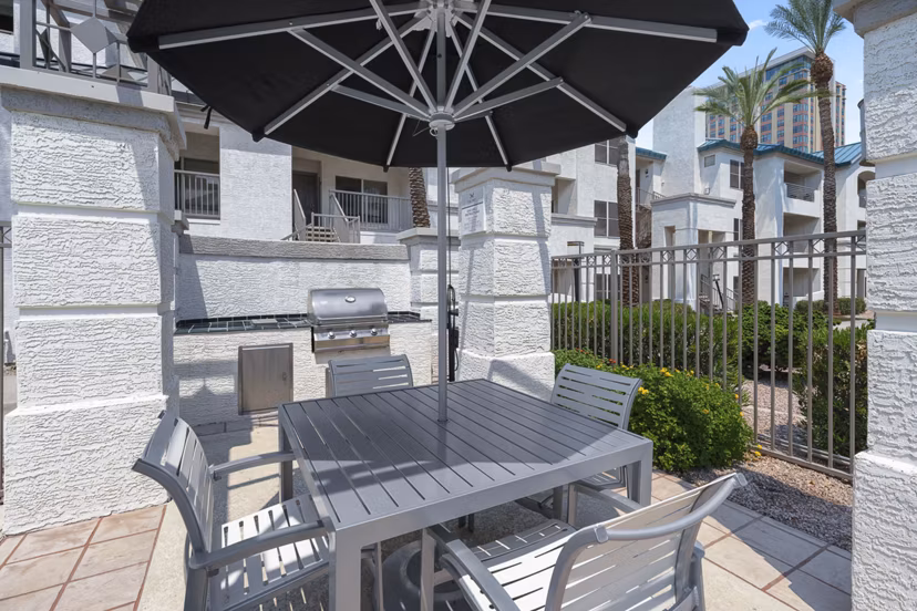 Grill area with modern BBQ facilities at The Met at 3rd and Fillmore Apartments