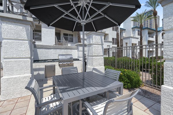 Grill area with modern BBQ facilities at The Met at 3rd and Fillmore Apartments
