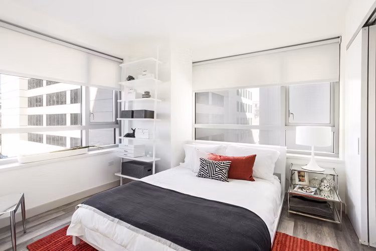 Cozy bedroom with modern decor at 33 8th St Apartments, luxury Greystar property in urban Boston