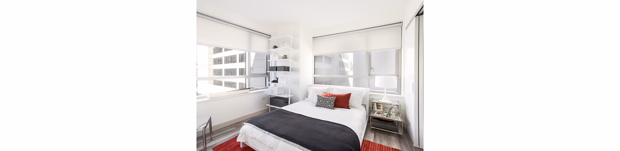 Cozy bedroom with modern decor at 33 8th St Apartments, luxury Greystar property in urban Boston
