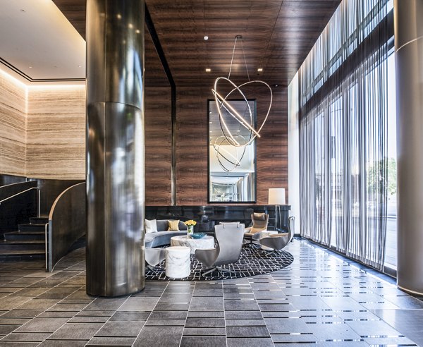 Clubhouse lobby with modern decor and seating at 33 8th St Apartments