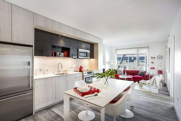 Dining area with modern furnishings at 33 8th St Apartments, offering luxury living with contemporary design elements