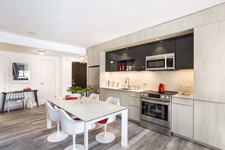 Modern kitchen with stainless steel appliances at 33 8th St Apartments
