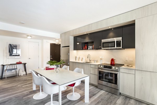 Modern kitchen with stainless steel appliances at 33 8th St Apartments