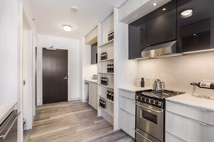 Contemporary kitchen with stainless steel appliances in 33 8th St Apartments
