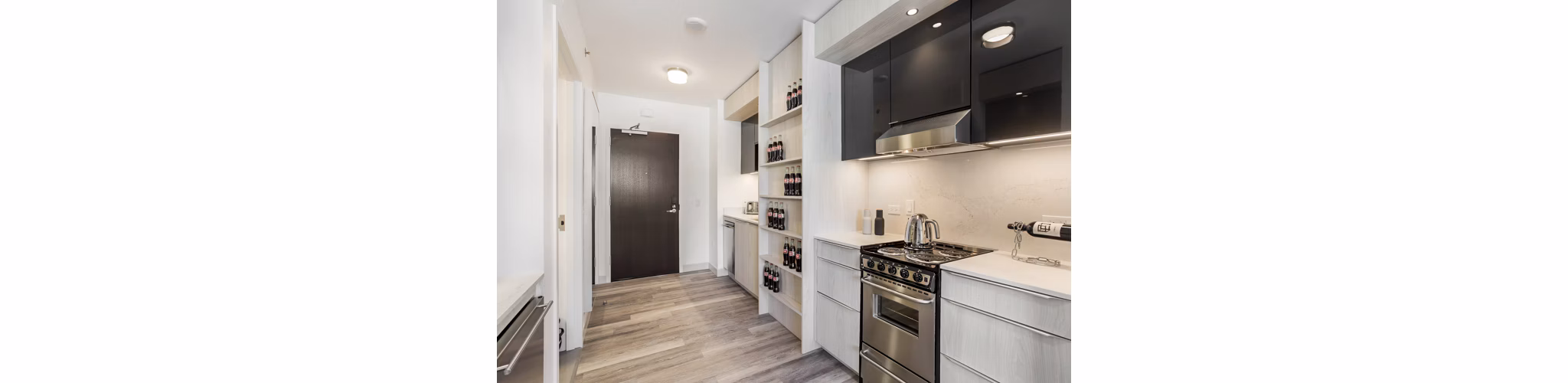 Contemporary kitchen with stainless steel appliances in 33 8th St Apartments