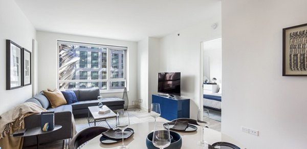 Spacious living room with modern decor in 33 8th St Apartments, a Greystar luxury property