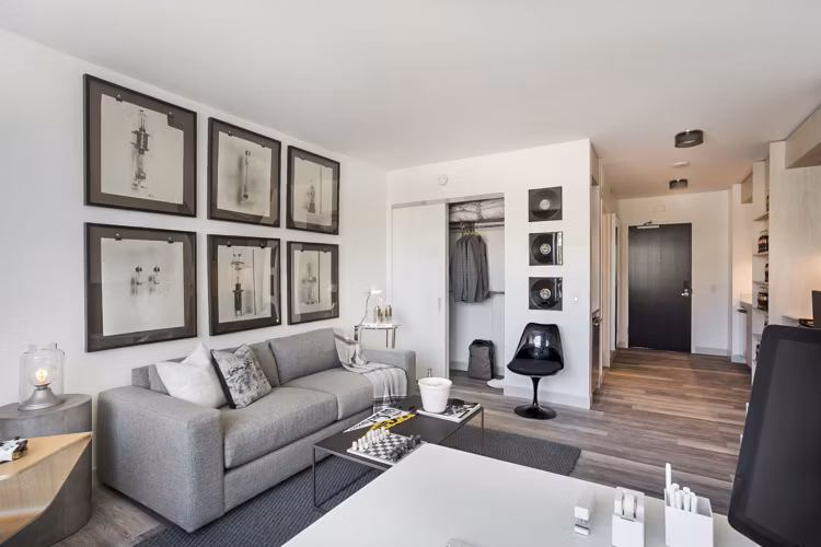 Spacious living room with modern decor and ample natural light at 33 8th St Apartments, a Greystar luxury community in Boston