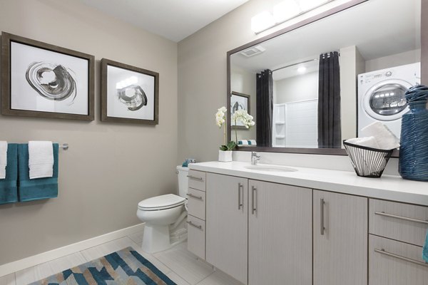 Baxter on Broadway Apartments: Modern bathroom with sleek fixtures and stylish tile design in luxury Oakland apartments
