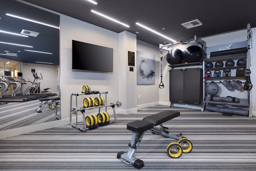 State-of-the-art fitness center equipped with modern gym facilities at Baxter on Broadway Apartments