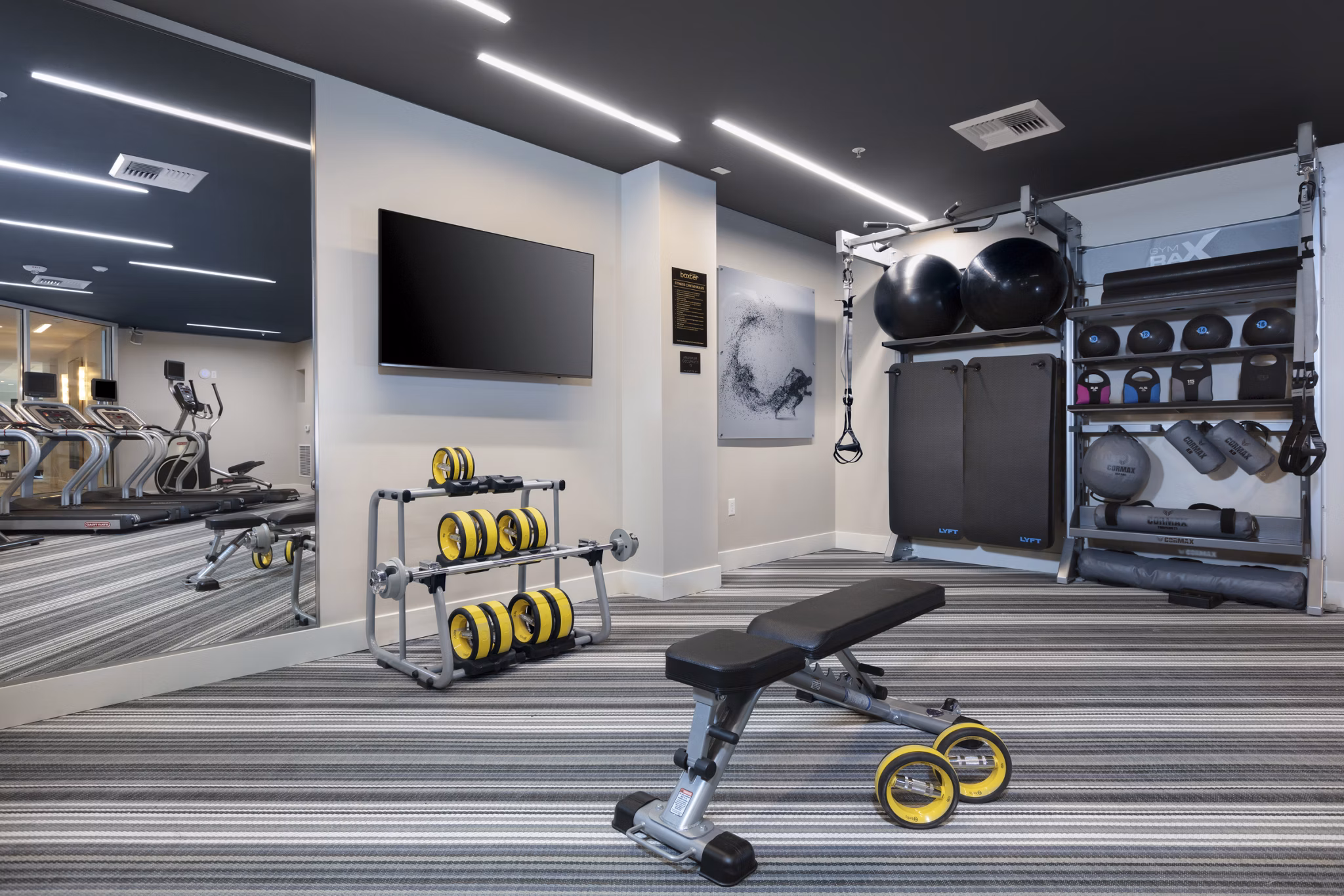 State-of-the-art fitness center equipped with modern gym facilities at Baxter on Broadway Apartments