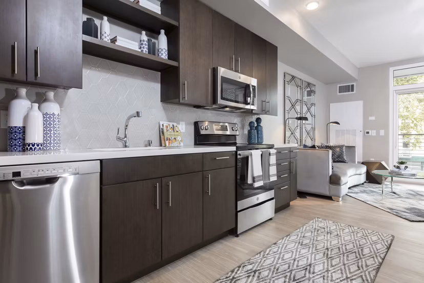 Modern kitchen with stainless steel appliances at Baxter on Broadway Apartments