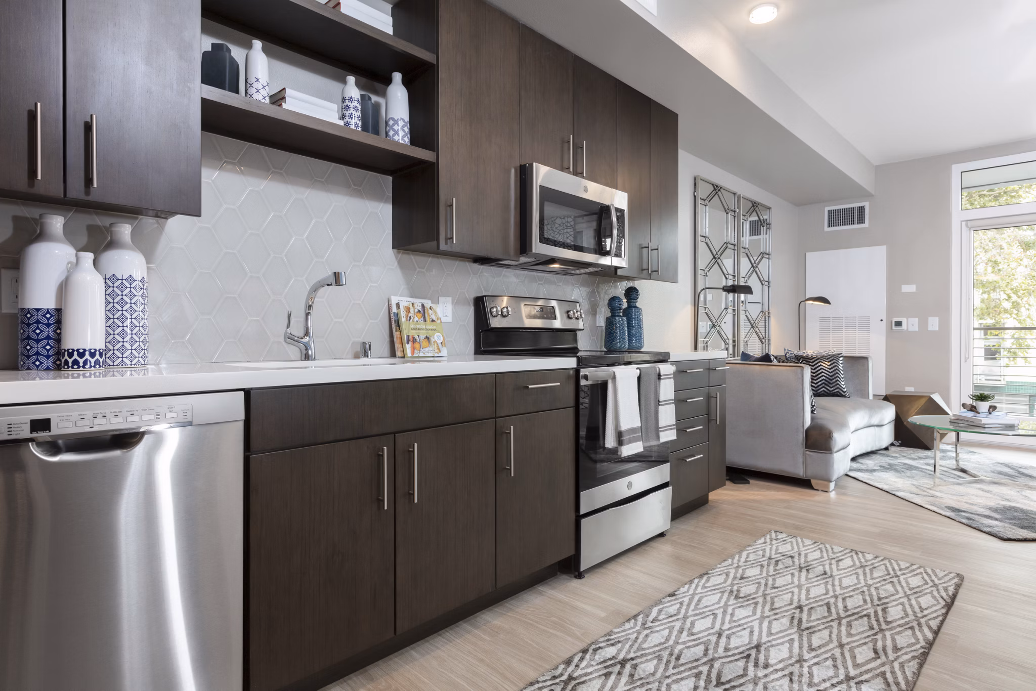 Modern kitchen with stainless steel appliances at Baxter on Broadway Apartments